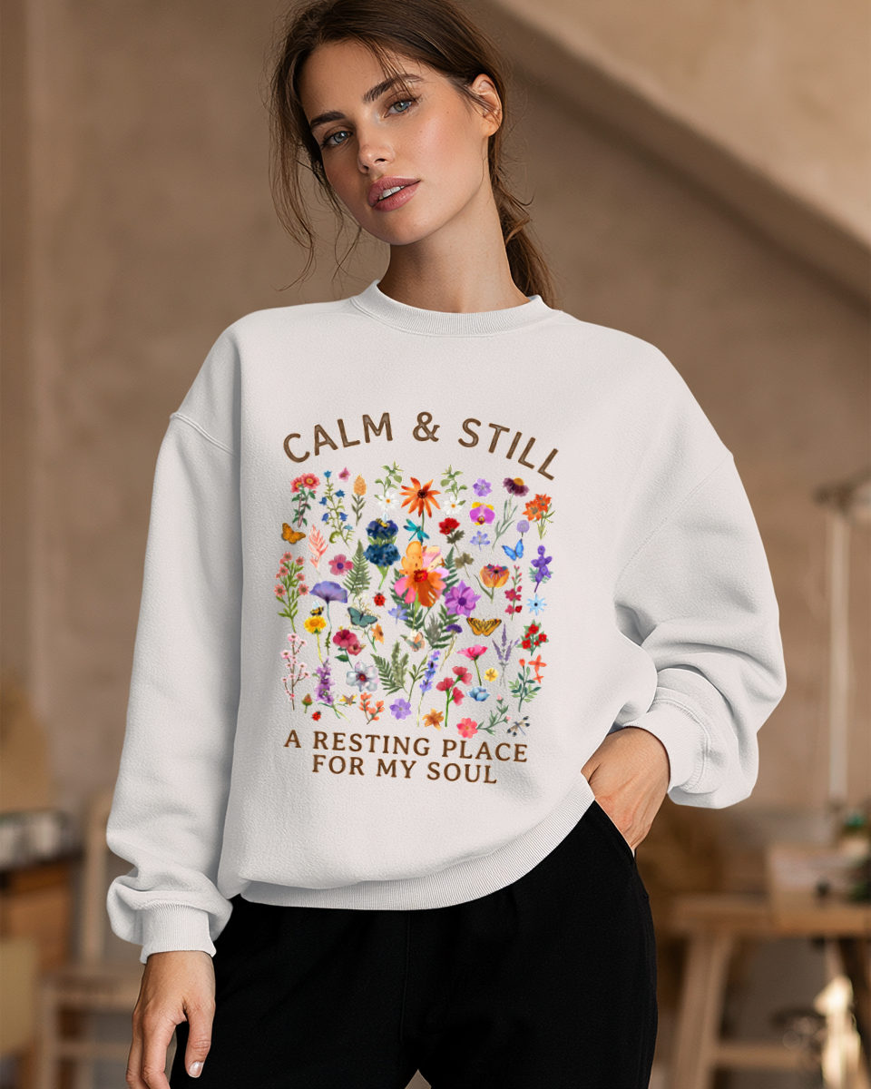 Woman wearing a white Women's Sweatshirt with Calm and Still colorful floral design